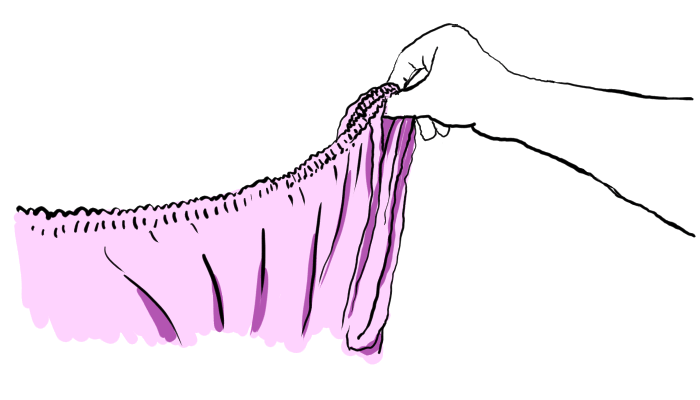 Right arm is holding the elastic where it meets the seams of two corners.