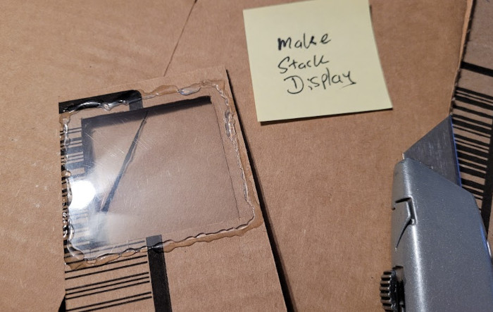 The back of the display has a hot-glued clear piece of plastic just big enough to show one note.