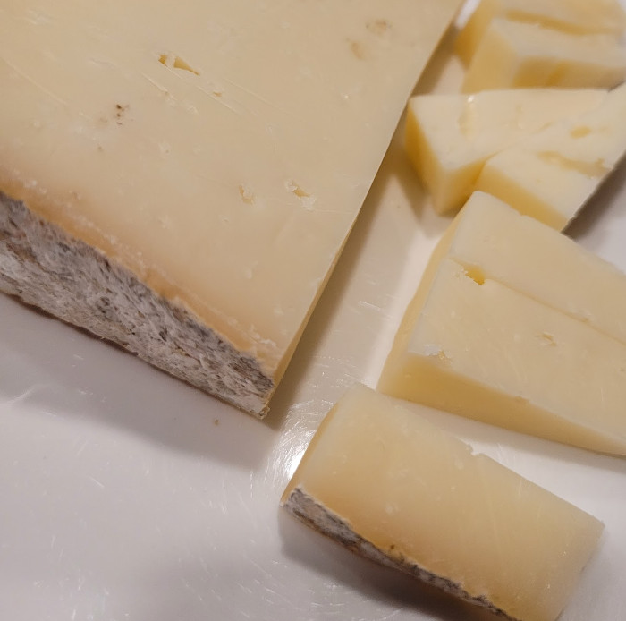 A wedge of the cheese cut into snack-sized pieces.