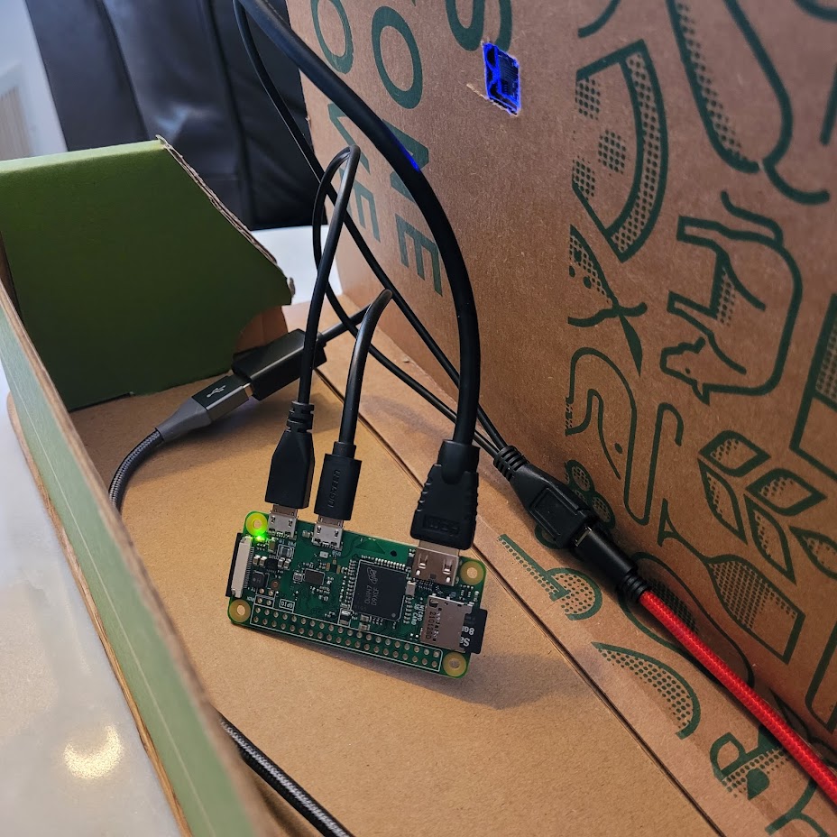 back view of my raspberry pi zero-powered cardboard laptop luggable computer showing the incredibly simple guts of the CPU box behind the screen