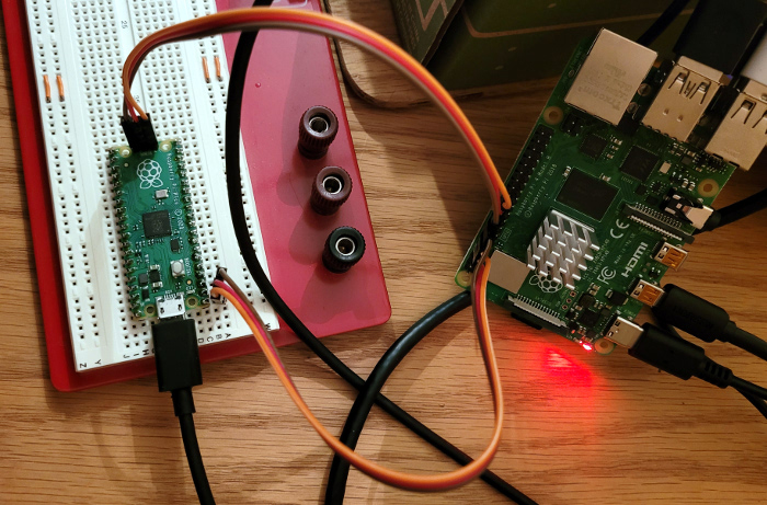 photo of raspberry pi pico connected via swd and uart pins to a raspberry pi 4 computer gpio