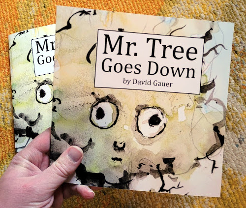 My hand holding a copy of the final print book