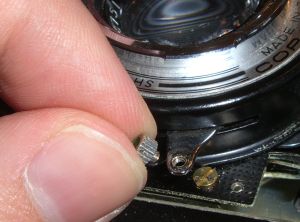 unscrew the shutter cock knob
